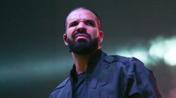 Drake Shoves Fan After They Try To Hug & Kiss Him During Concert Walkout